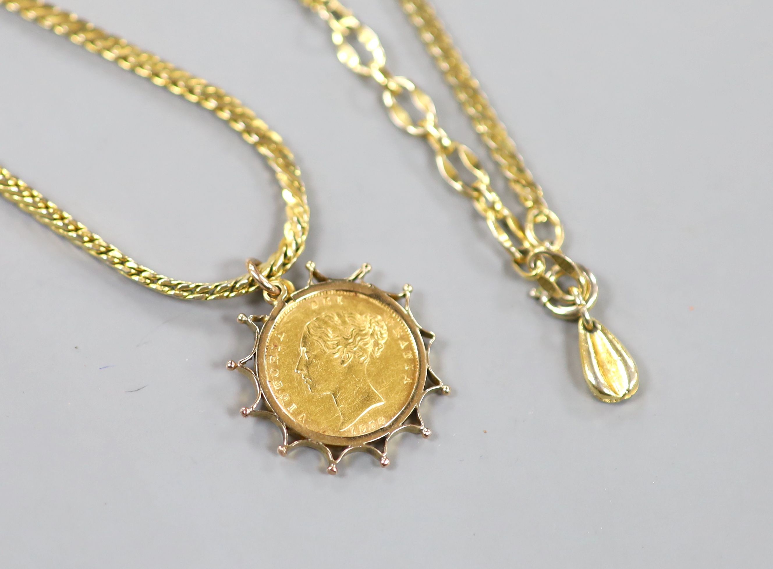 An 1878 gold half sovereign, in yellow metal pendant mount, on a gilt metal chain.
